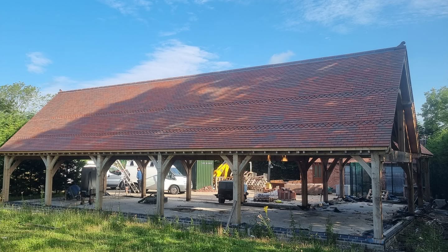 Clay tiled roof on a large oak-framed barn — traditional roofing by JP Bobcat Roofing, Warwickshire