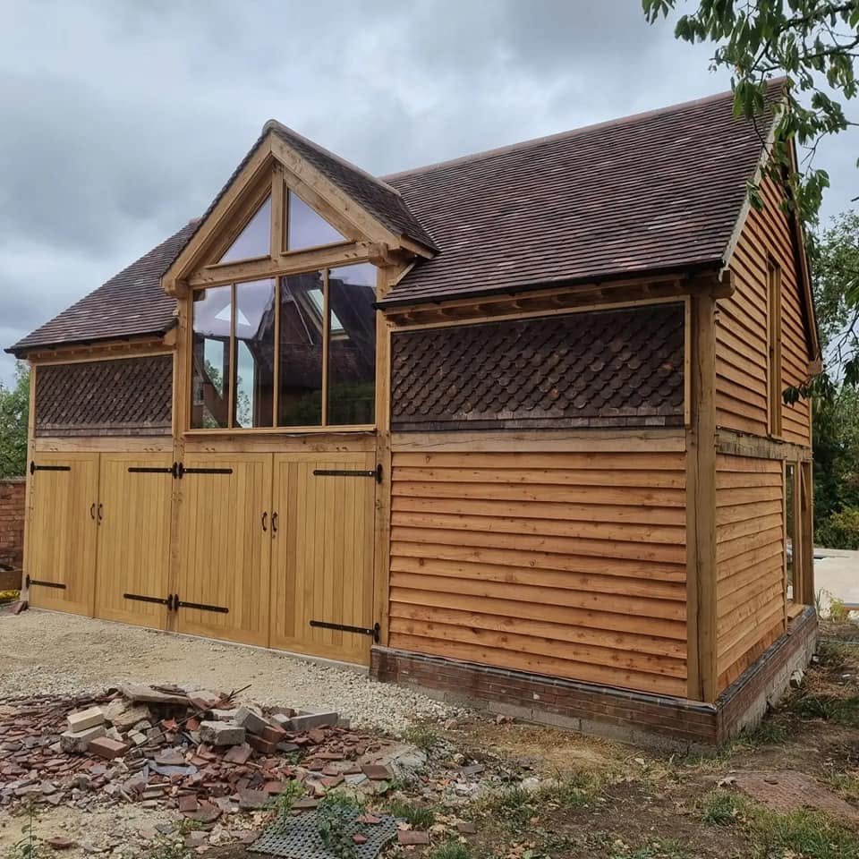 New tiled roof on an oak-framed garage with clay tile detailing — bespoke roofing by JP Bobcat Roofing, Warwickshire