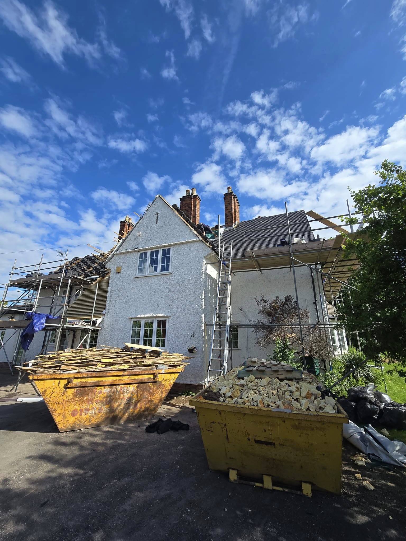 Full re-roof in progress by JP Bobcat Roofing — scaffolded and managed from start to finish in Warwickshire
