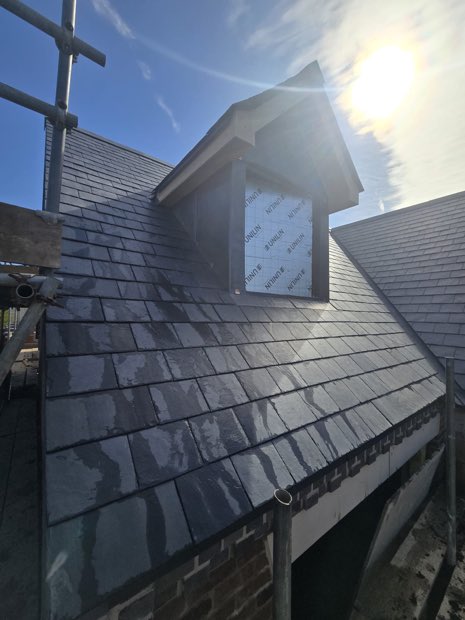 Bespoke lead dormer with dressed lead cheeks set into a Spanish slate roof in Barby, Warwickshire