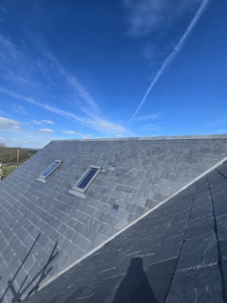Rooflights cut into a Spanish slate roof slope on a new build in Barby, Warwickshire
