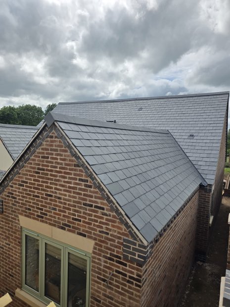 Completed Spanish slate roof over brickwork on a new-build bungalow in Barby, Warwickshire