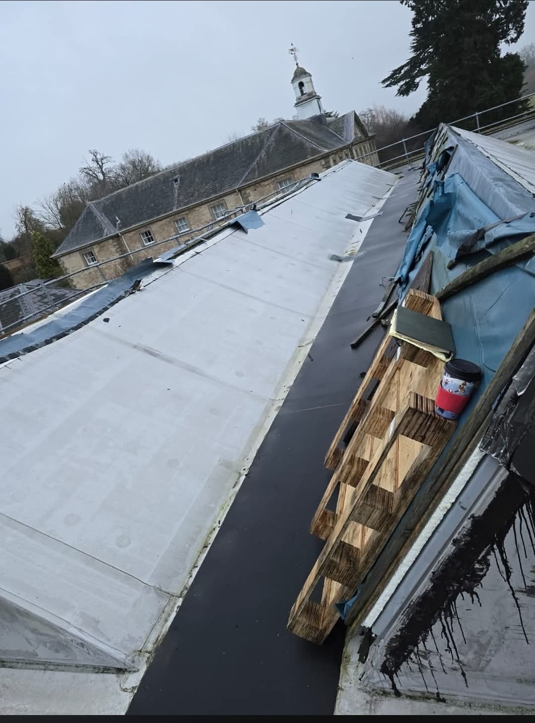 Resitrix flat roof installation in progress at Compton Verney, Warwickshire, with the historic house and its cupola behind