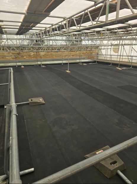 Large expanse of new Resitrix flat roofing beneath a temporary roof and birdcage scaffold at Compton Verney