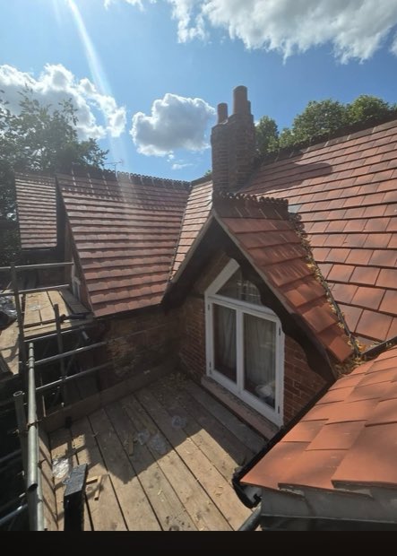 Uttoxeter re-roof in progress with a dormer and new clay-red tiles being laid