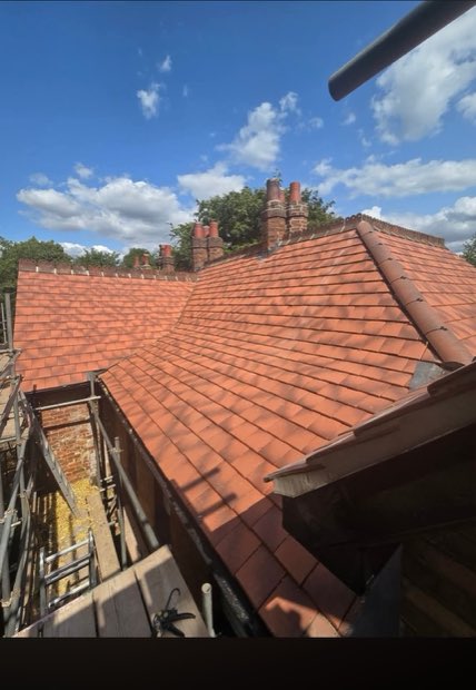 Sweeping re-tiled roof slope with new ridge tiles on a period property in Uttoxeter