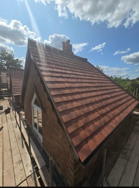 Completed gable elevation with new tiling and ornamental ridge in Uttoxeter, Staffordshire