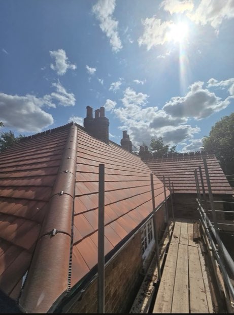 Ridge and hip detail on a completed clay-tiled re-roof in Uttoxeter, Staffordshire
